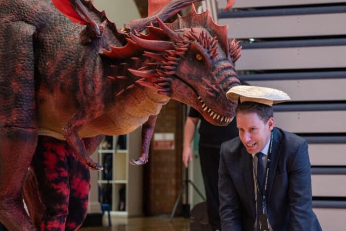 Sol the dragon blindfolded interacting with a teacher